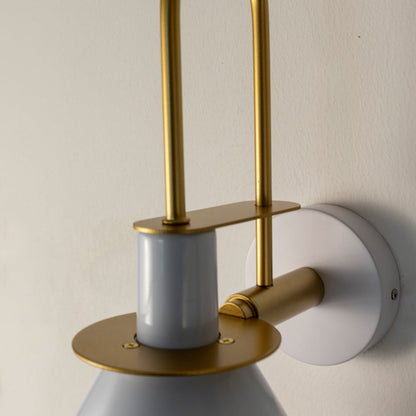 Closeup of white and gold wall sconce showing smooth metal finish and refined craftsmanship for luxury decor.