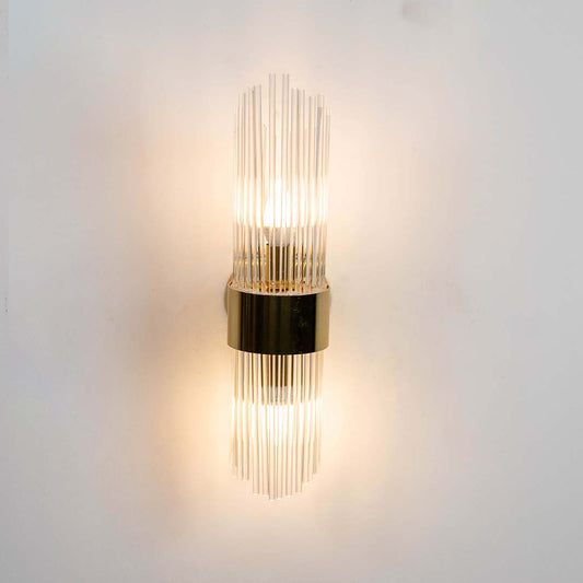 Metal and clear glass rod wall light shown with light on against a white background highlighting its warm illumination for home decor.
