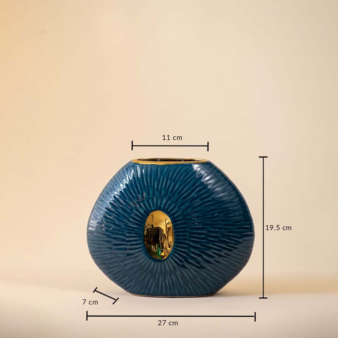 Blue oval ceramic vase with gold accent featuring 19.5 cm height  27 cm width  and 7 cm depth displayed on beige background.