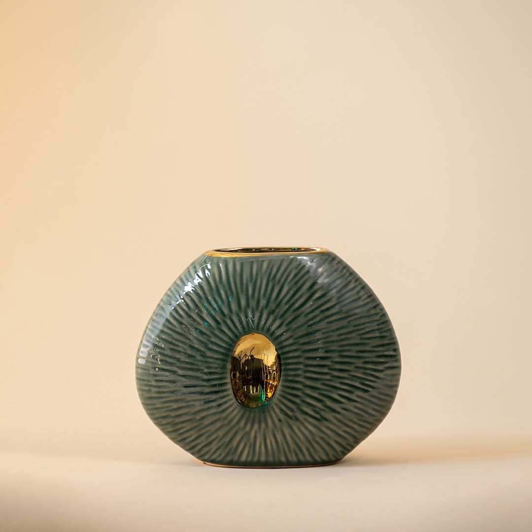 Detailed textured green oval vase with central gold accent for sophisticated home decor and shelf display.
