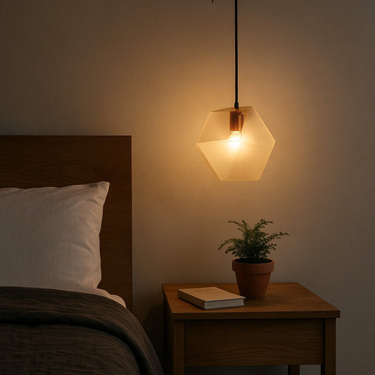 Frosted geometric pendant light on beside a wooden bed casting a warm glow that enhances minimalist bedroom decor with soft ambient illumination.