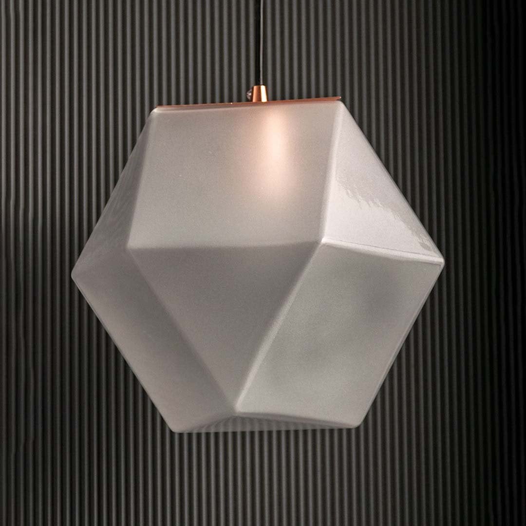 Frosted geometric pendant light off against a black background showing detailed faceted glass design and modern minimalist style for interiors.