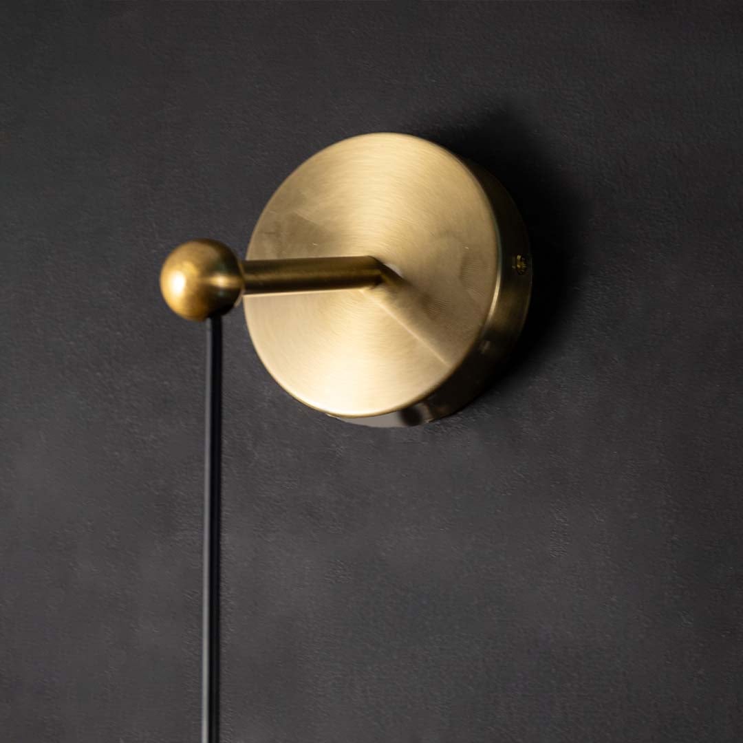 Closeup view of faceted crystal pendant light with gold metal top showing reflective surfaces and modern detailing for luxury interior lighting.