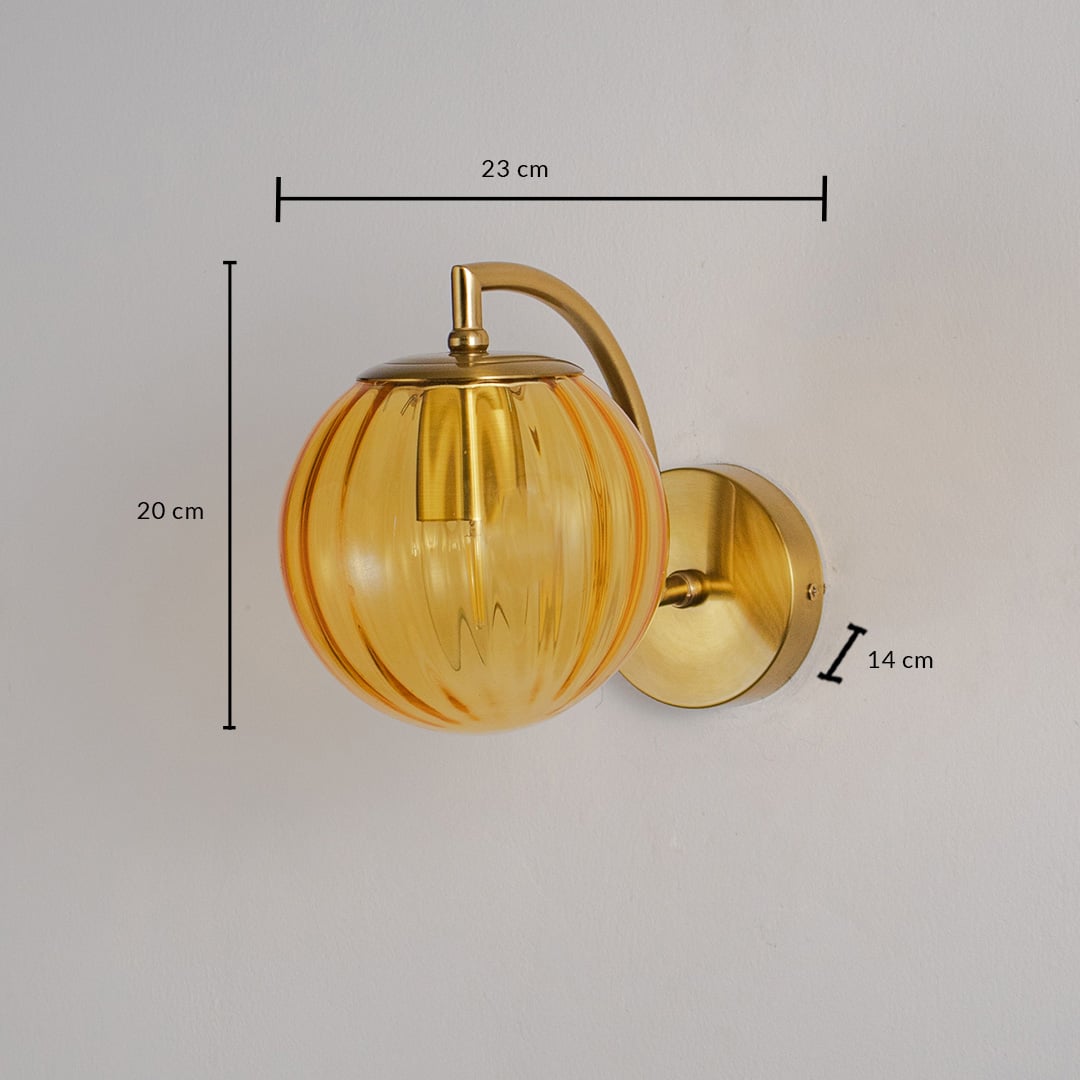 Brass wall lamp with amber glass shade measuring 20cm height 23cm width and 14cm depth decorative wall lighting.