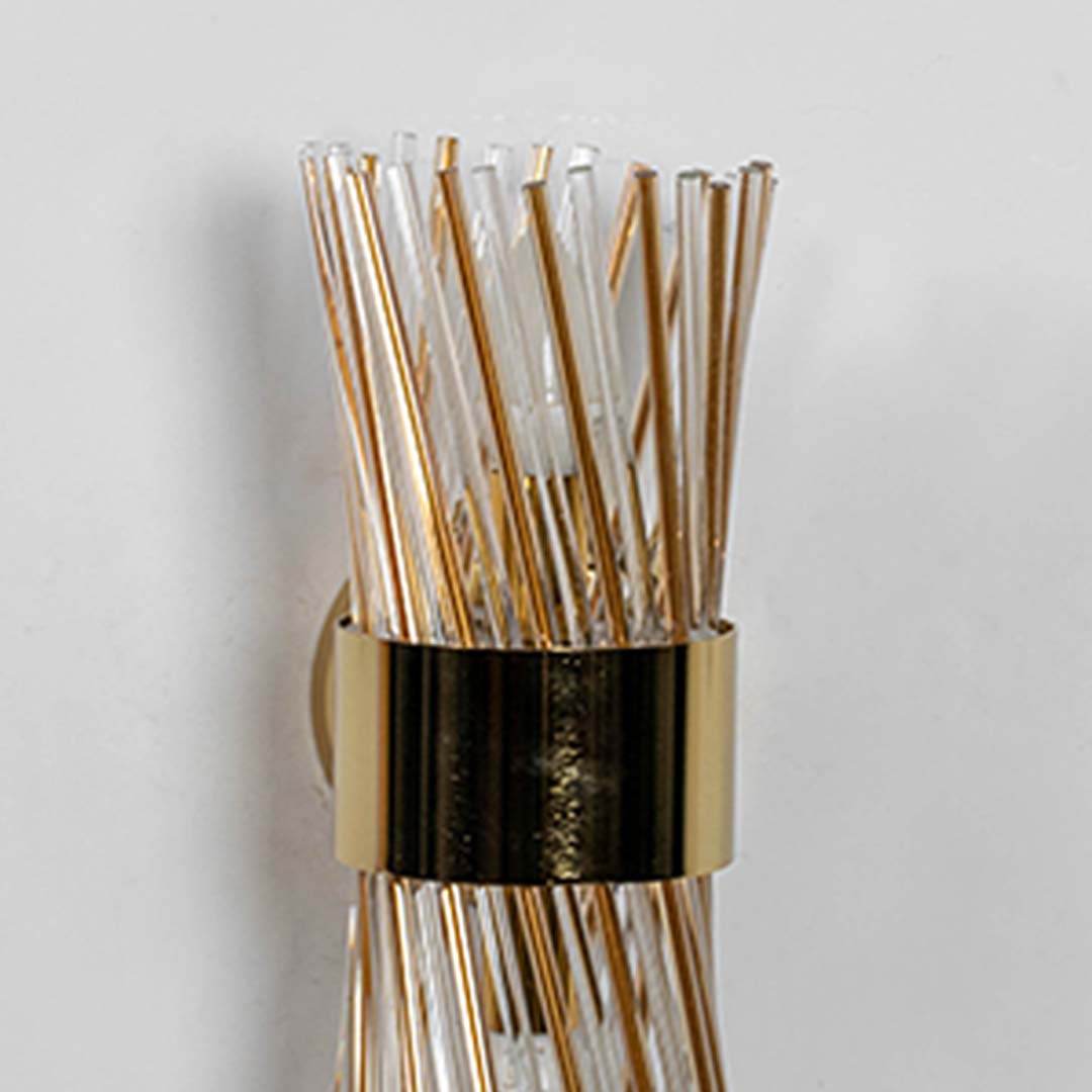 A closeup view of the metal band and glass rods of the wall light revealing elegant textures and refined craftsmanship for modern home interiors.