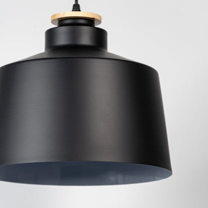Black metal pendant light showcasing smooth matte texture and industrial drum silhouette for modern interior styling.