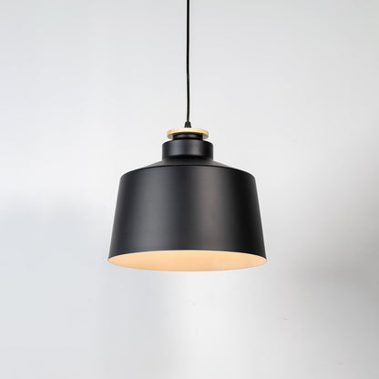 Black metal pendant light with matte finish and industrial drum design for contemporary ceiling lighting decor.