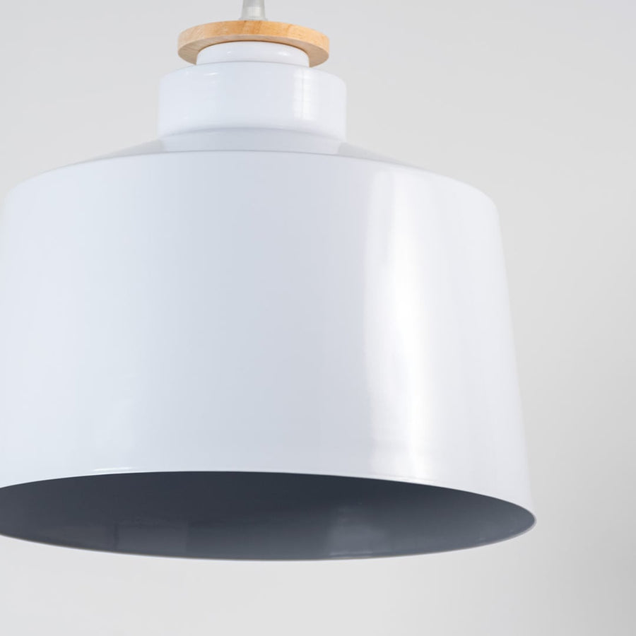 A detailed closeup of the white pendant light showing the smooth shade texture and refined top detailing emphasizing the elegant craftsmanship suitable for modern interiors.