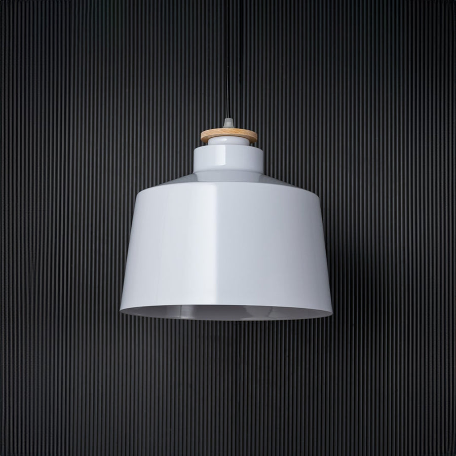 A white pendant light shown off against a black background highlighting its clean modern silhouette and smooth finish that blends effortlessly with minimalist interiors.