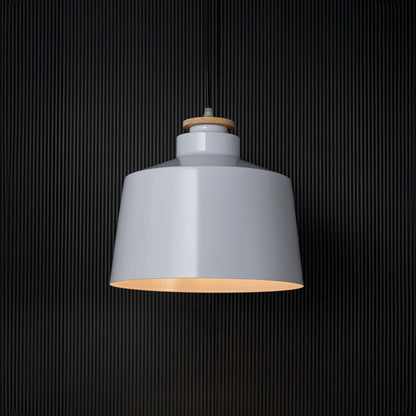 A white pendant light glowing against a black background creating a striking contrast while showcasing its smooth shade and soft warm illumination for modern decor.