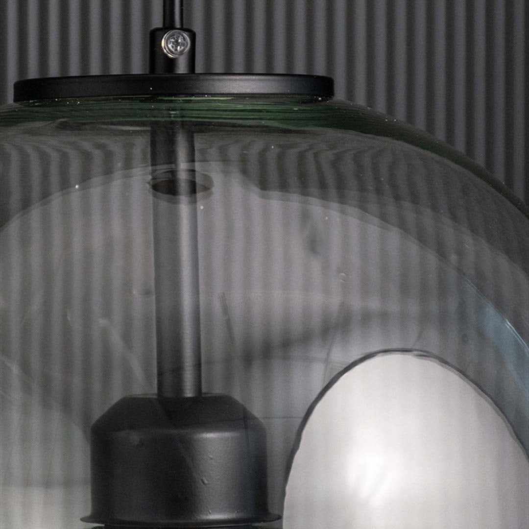 Closeup of ribbed glass pendant light top section with black metal cap showing refined texture and luxury ceiling lighting detail.