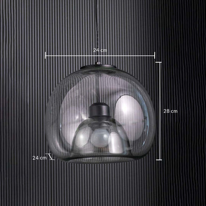 Table lamp with a clear glass dome pendant measuring 24 cm wide and 28 cm tall shown against a dark vertical panel background.