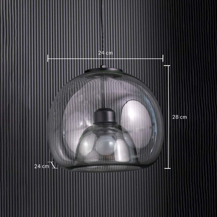 Table lamp with a clear glass dome pendant measuring 24 cm wide and 28 cm tall shown against a dark vertical panel background.