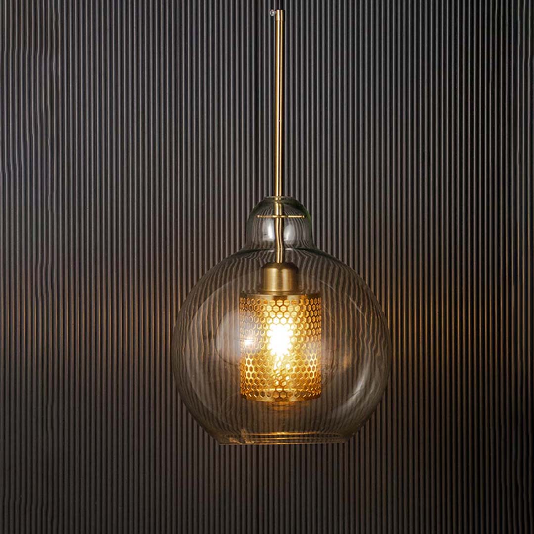 Modern glass pendant lamp glowing warm light with golden mesh detailing luxury hanging ceiling light for living and dining room.