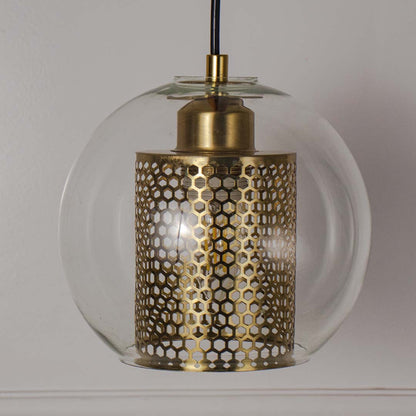 Decorative golden glass pendant light with perforated inner shade perfect for dining room or living space.
