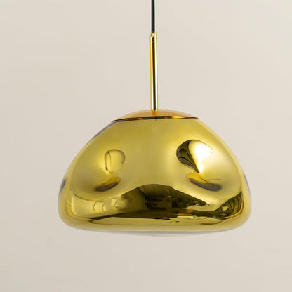 A closeup of the gold metallic pendant light highlighting its glossy curved dome surface and warm inner glow for stylish modern decor.