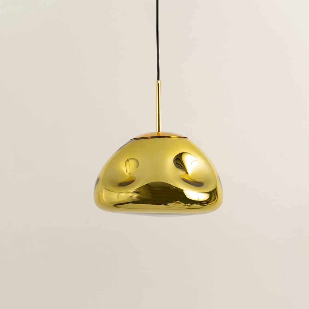 A gold metallic pendant light displayed with lights off on a white background showing its glossy curved dome form for minimalist interior styling.
