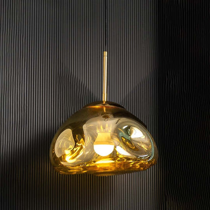 A gold metallic pendant light displayed with lights off on a white background showing its glossy curved dome form for minimalist interior styling.