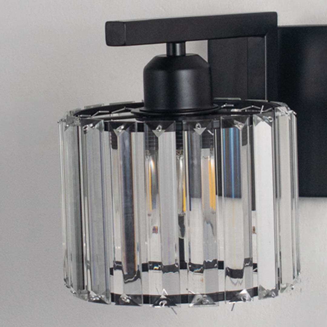 Elegant brass wall light with warm glow and cone glass shade for modern bedroom decor.