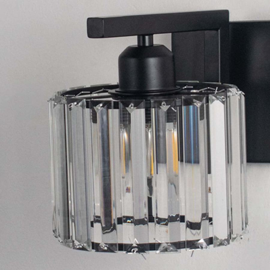 Elegant brass wall light with warm glow and cone glass shade for modern bedroom decor.