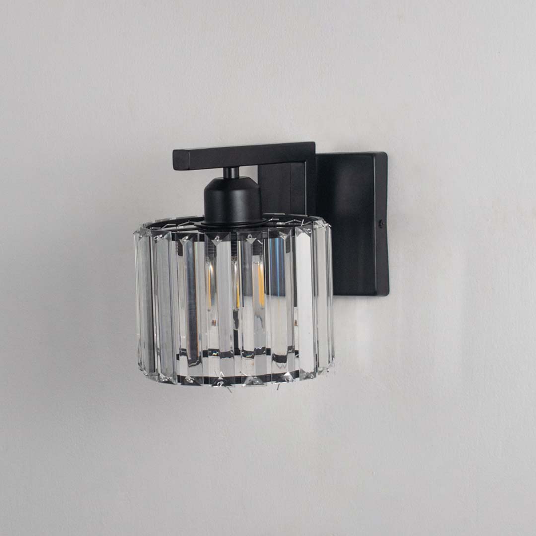 Black and crystal wall light turned off against a white background showing its clear crystal shade and clean minimal form without illumination.