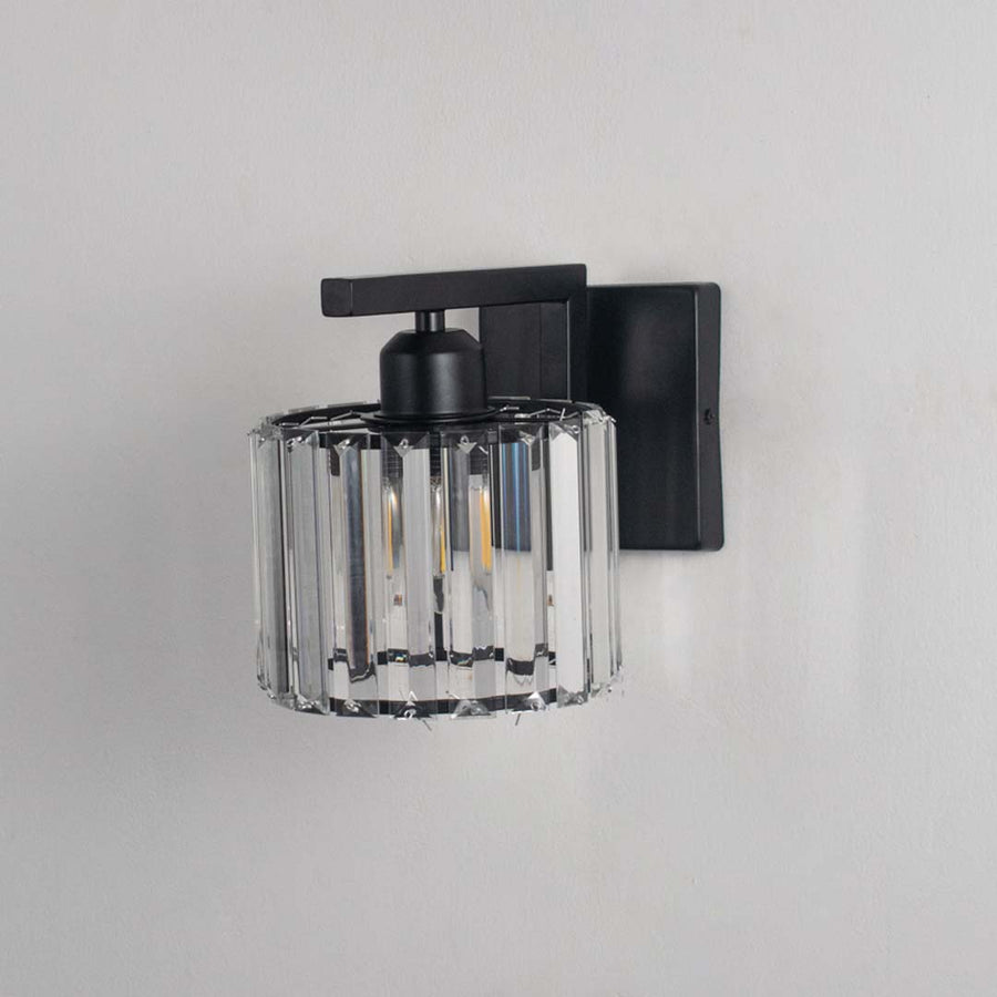 Black and crystal wall light turned off against a white background showing its clear crystal shade and clean minimal form without illumination.