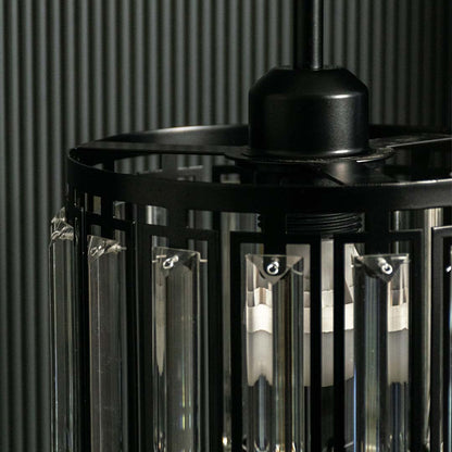 Closeup of black metal chandelier with smoked glass rods highlighting premium craftsmanship.