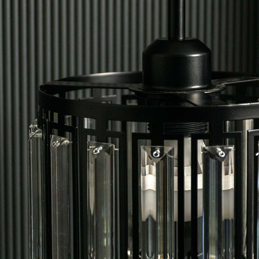 Closeup of black metal chandelier with smoked glass rods highlighting premium craftsmanship.
