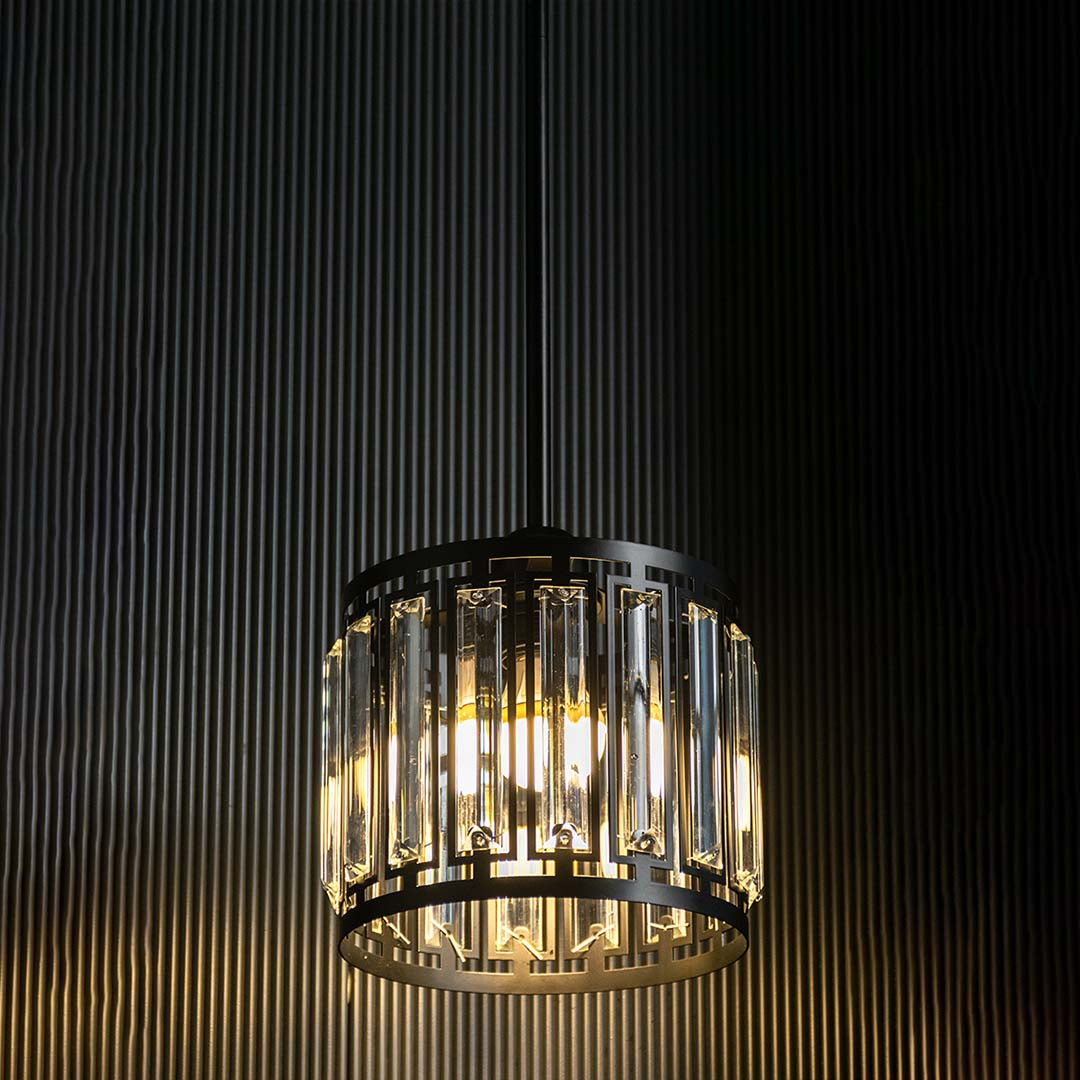 Crystal glass chandelier with gold metal frame illuminated for luxurious contemporary spaces.