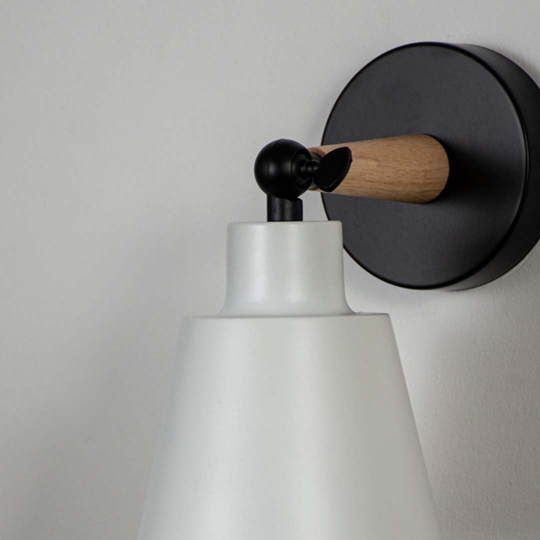 Closeup of modern wall lamp with matte white shade wooden touch and black base showcasing premium wall mounted lighting.