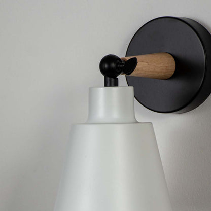 Closeup of modern wall lamp with matte white shade wooden touch and black base showcasing premium wall mounted lighting.