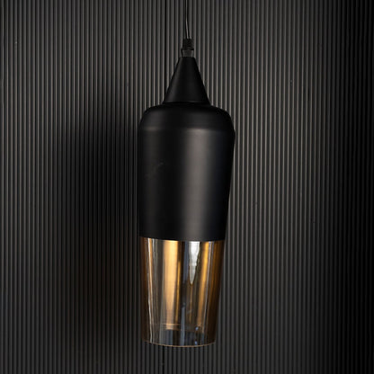 Sleek cylindrical hanging light fixture with black top and amber bottom turned off isolated on a pitch black background for contrast.