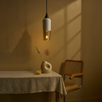 Amber glass pendant light casting a warm glow beside the bed with elegant contemporary charm.