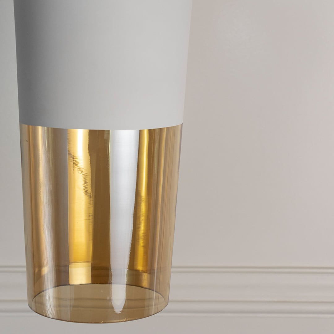 Detailed closeup view of the matte white finish on the top section of the cylindrical pendant light fixture highlighting the material quality.