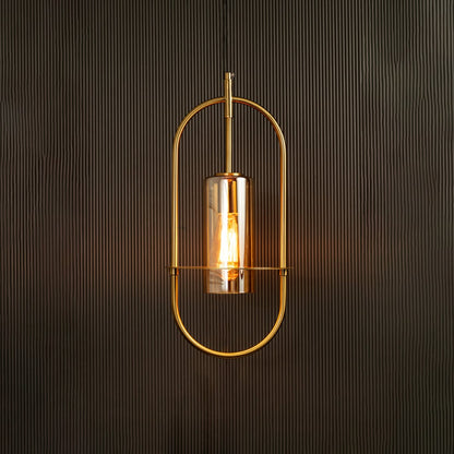 Hanging pendant light illuminated against a dark background emphasizing its curved metal frame and warm amber-toned light.
