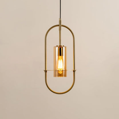 Gold metal wall light with clear glass shade illuminated to showcase elegant modern wall lighting design.