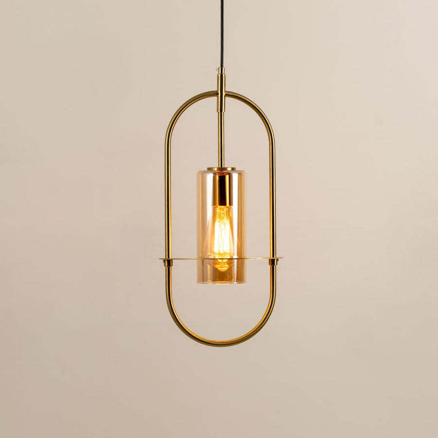 Gold metal wall light with clear glass shade illuminated to showcase elegant modern wall lighting design.
