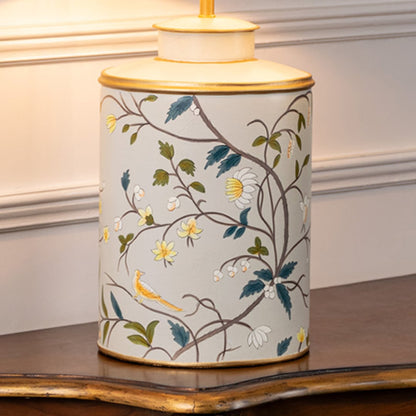 Closeup image highlights ceramic lamp base with detailed floral branches birds and gold rim accents showing fine craftsmanship.