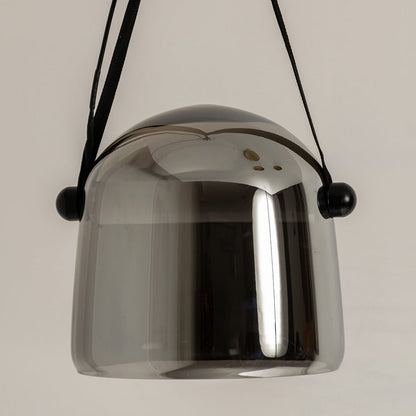 Closeup view of chrome glass pendant lamp with black strap highlighting reflective finish and premium design.