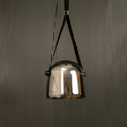 Modern chrome glass pendant lamp with black strap displayed on black background adding style to interior design.