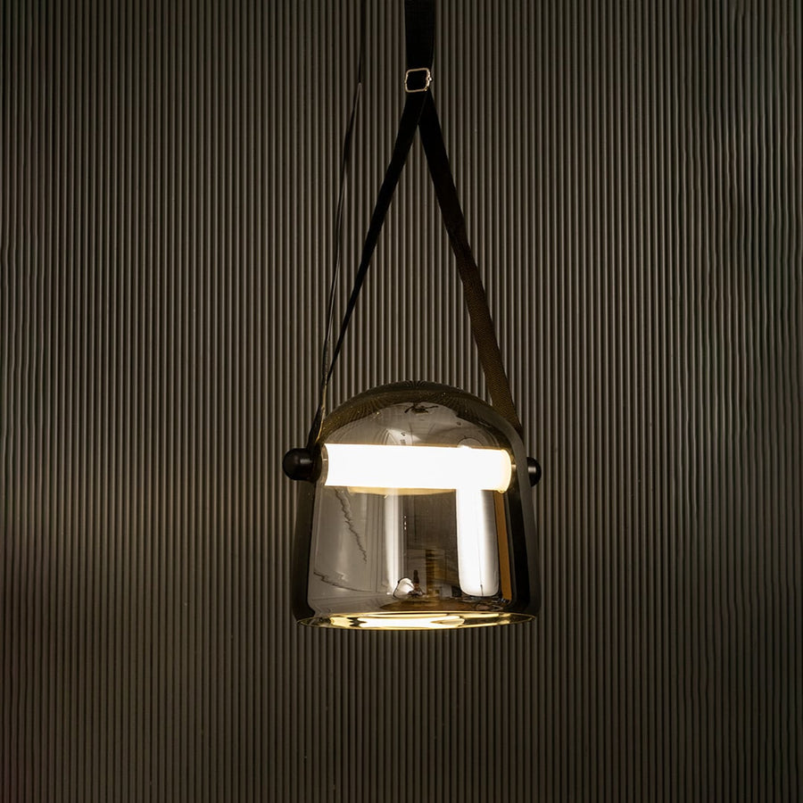 Chrome glass pendant light glowing beautifully on black background ideal for living room or dining space lighting.
