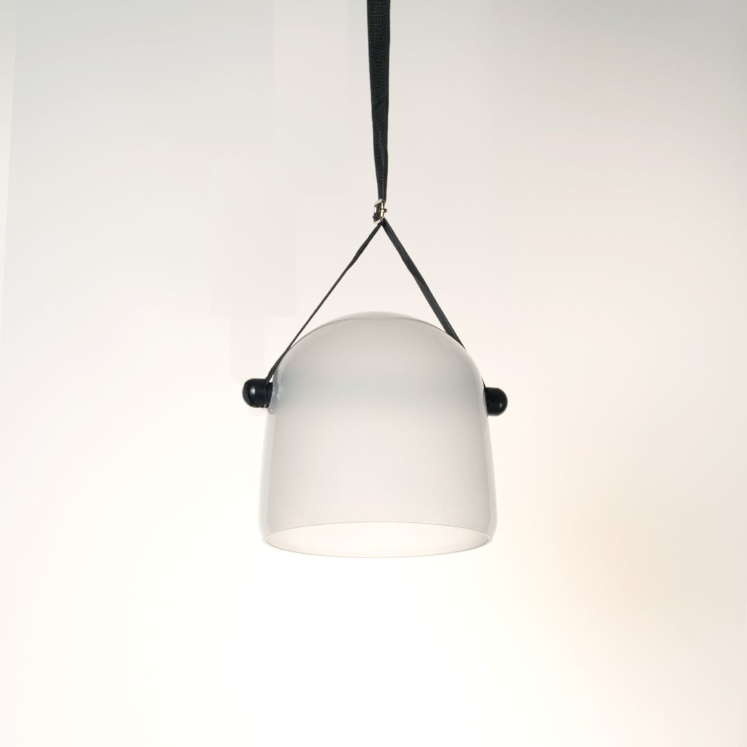 Elegant frosted white glass pendant lamp lit on white background ideal for bedroom dining and living room use.