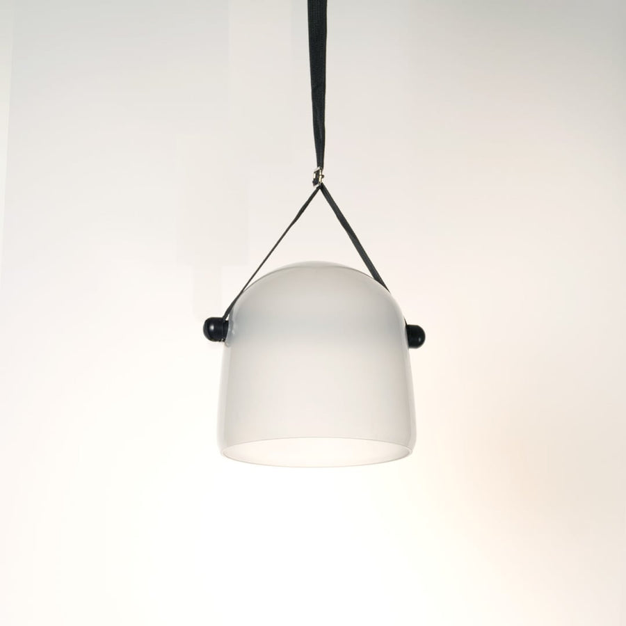 Elegant frosted white glass pendant lamp lit on white background ideal for bedroom dining and living room use.
