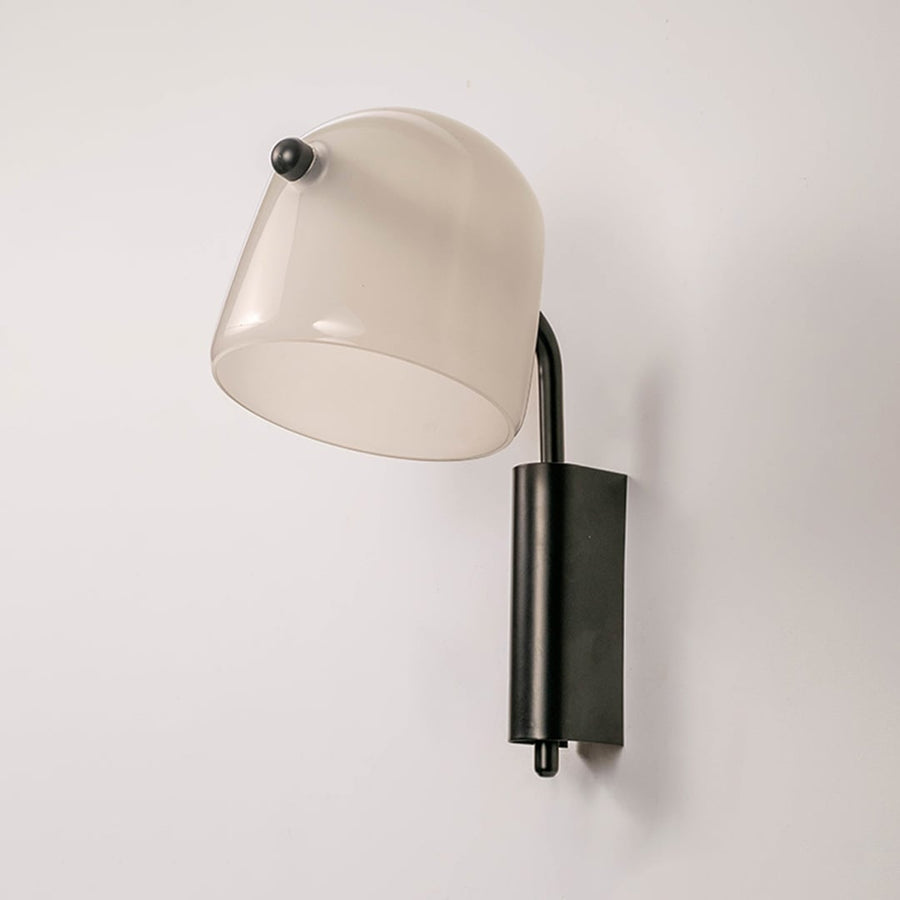 Frosted white glass wall sconce with black metal fixture light off on white background stylish wall light for living area.