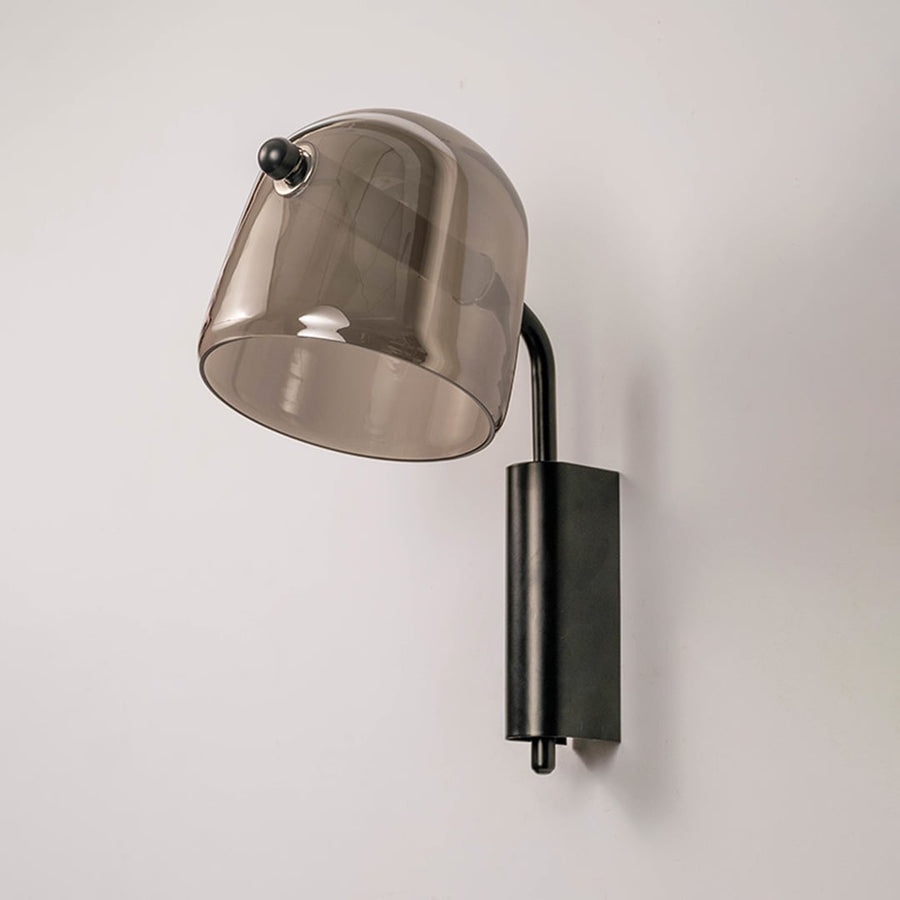 Smoked glass wall sconce with black metal base light off on white background modern wall lighting for hallway and living area.