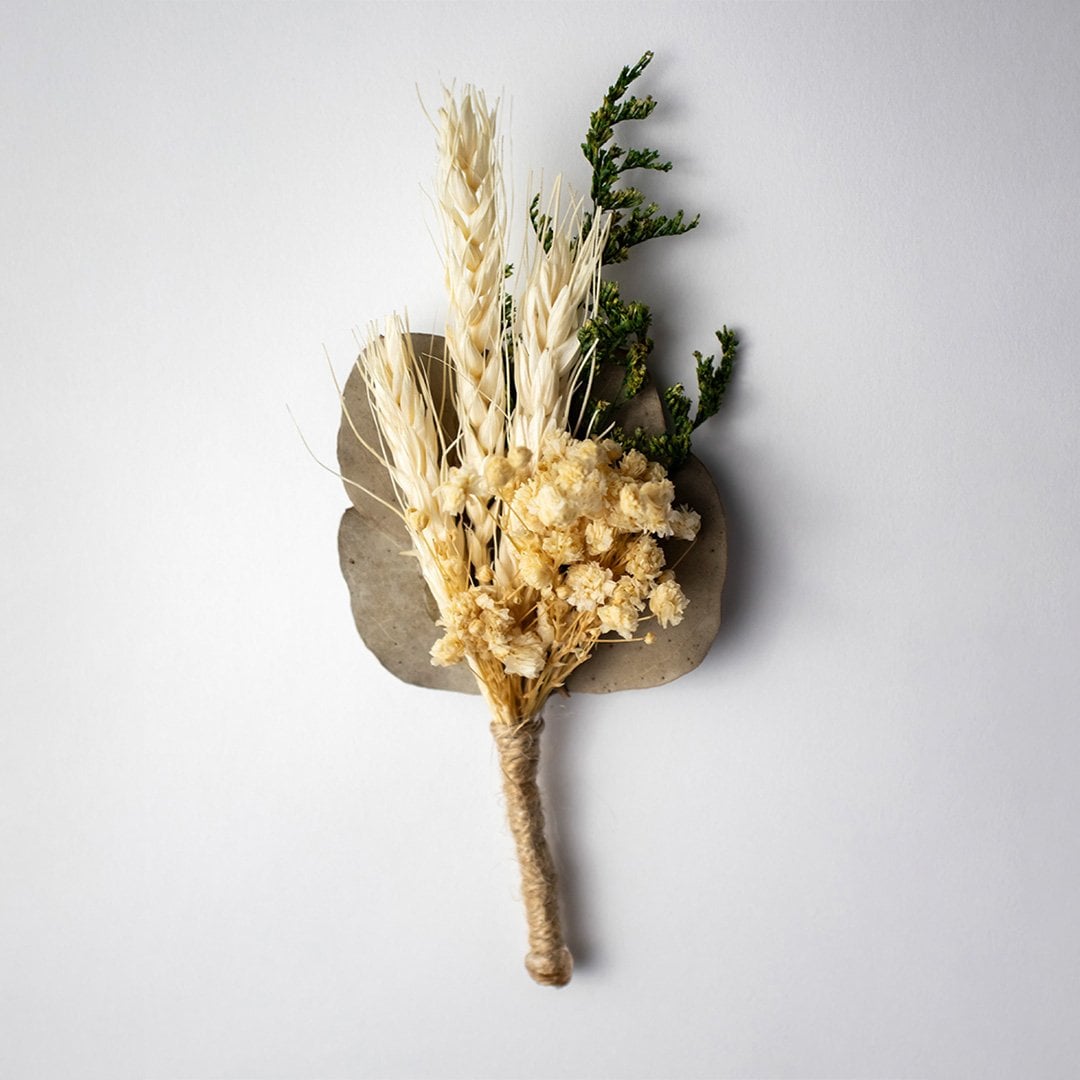 Rustic dried flower bouquet with wheat stalks preserved greenery and natural jute wrap perfect for home decor styling.