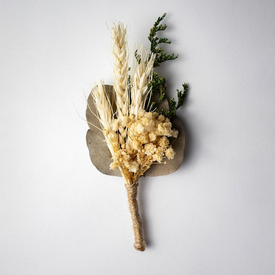 Rustic dried flower bouquet with wheat stalks preserved greenery and natural jute wrap perfect for home decor styling.