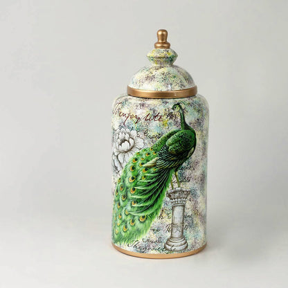 Decorative ceramic jar with parrot and botanical artwork and gold lid placed on white surface against neutral background showcasing luxury artistic home decor styling.