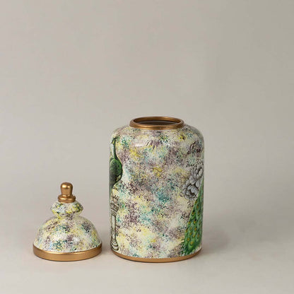 Detailed closeup of ceramic jar showcasing intricate peacock feathers and floral background artistry with glossy golden rim.