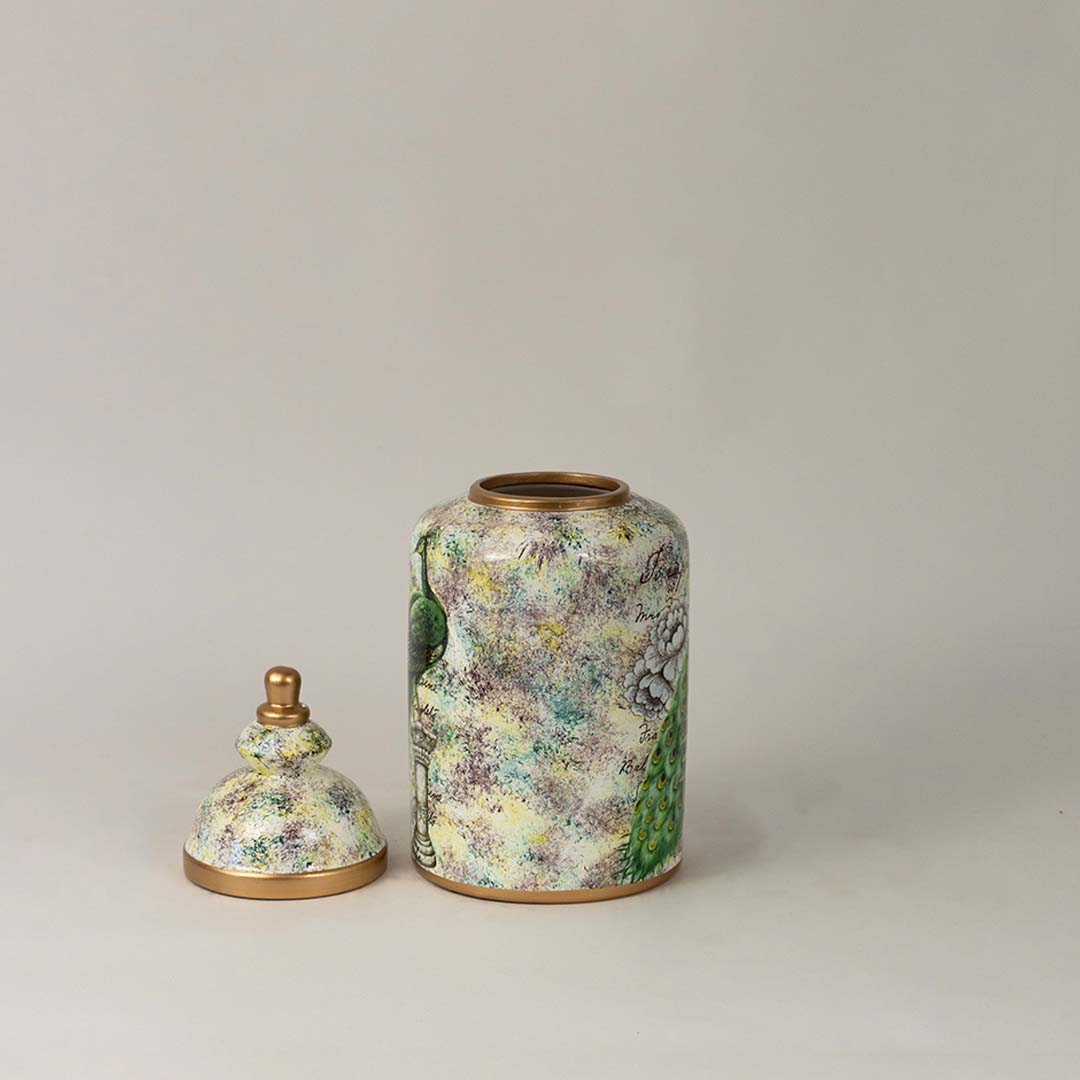 Elegant ceramic jar with golden lid featuring a detailed green peacock illustration perfect for home and office décor.